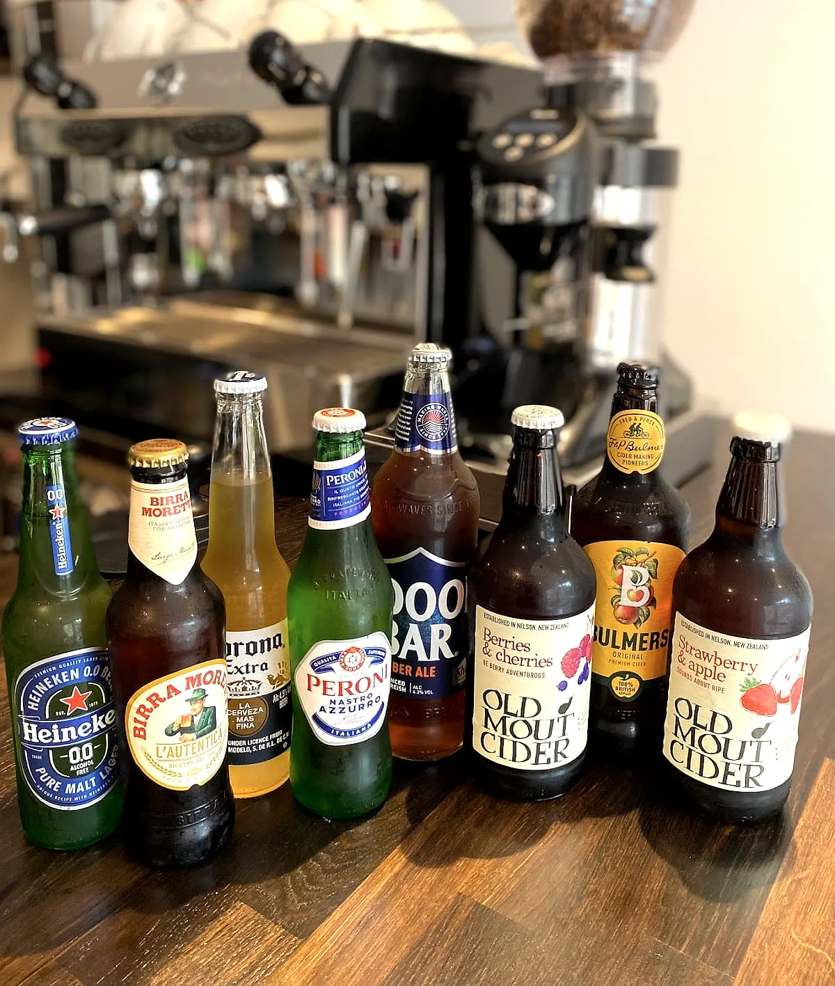 A row of bottled beers and ciders on the bar