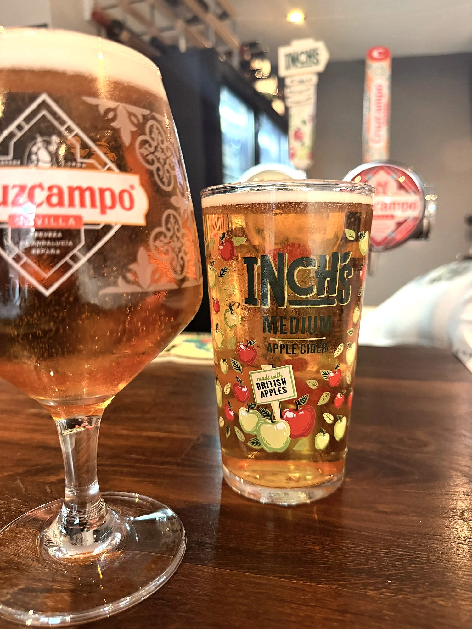 A glass of Cruzcampo and a pint of Inch's cider on the bar