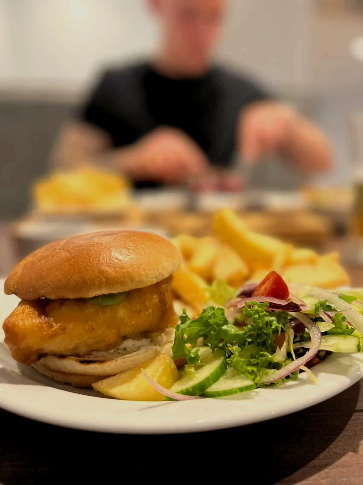 Fish burger with chips and salad